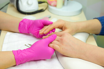 Closeup shot of a woman in a nail salon receiving a manicure. Woman getting nail manicure. .