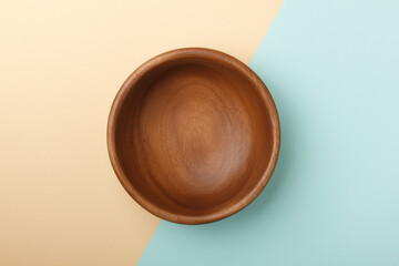 Empty wooden plate on paper background.