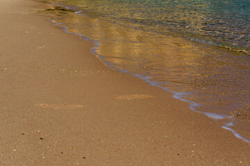 Closeup of the sand on beach and Red sea water