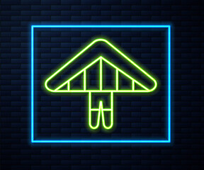 Glowing neon line Hang glider icon isolated on brick wall background. Extreme sport. Vector Illustration.