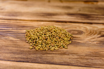 Heap of the fenugreek seeds on wooden table