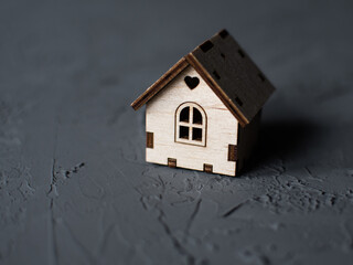 Obraz na płótnie Canvas small wooden house on a gray background