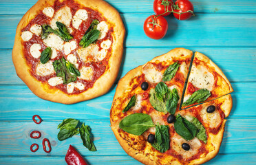 Homemade pizza margarita with mozzarella, tomatoes and basil on the blue wooden background