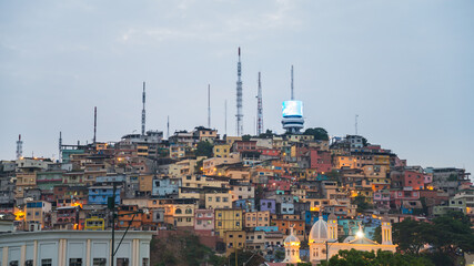 Close-up of a neighborhood of Guayaguil, Ecuador, in the evening. In the area there are several colored buildings on a hill.