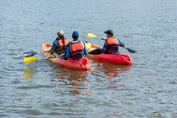 Three kayakers kayak on the Potomac River in Washington, D.C.