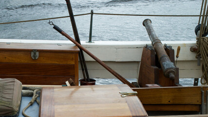 Vintage ship's cannon on the deck of an old sailing ship