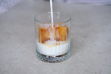 Ice cubes made with coffee in glass, preparing refreshing coffee drink