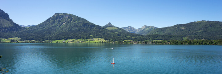 Fototapeta na wymiar Panorama from Landscape of Wolfgangsee lake with its surrounding mountains. Austria