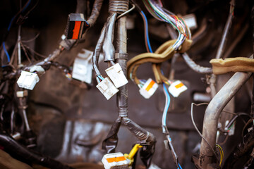 Close up of the engine control unit of the car, multicolored wires plug, contacts - a wiring of a truck car. Electrical communication, wires in an old car