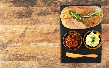 Bread, bruschetta and herbs butter on the table.