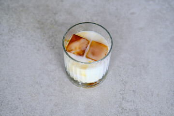 Ice cubes made with coffee in glass, preparing refreshing coffee drink