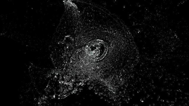 Water exploding in slow motion and spreading droplets on a black background