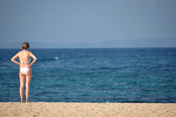 Woman enjoying blue sky and beach