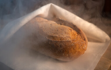 Freshly baked bread wrapped in a towel.