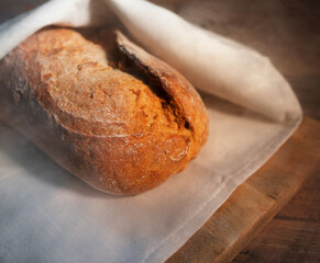 Freshly baked bread wrapped in a towel.