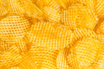 background of salted lattice cut potato chips with paprika flavor
