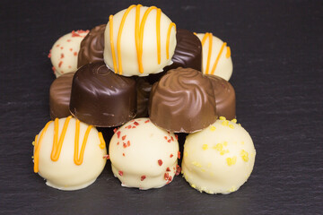heap of different white and dark chocolate truffles