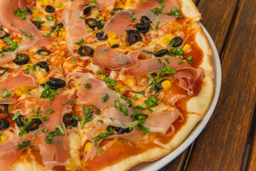 Tasty hot italian pizza with ham, mushrooms and olives.  Traditional Italian food. Concept poster for Restaurants or pizzerias.
