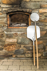 Old stone homemade pizza oven. Fire in the furnace. Homemade baking pizza. Bakery. Traditional Italian food.