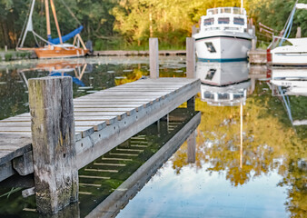 29 Close up and selective focus of wooden jetty in the private staithe at Barton Turf in the heart...
