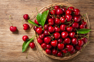 fresh cherries on a wooden table, top view