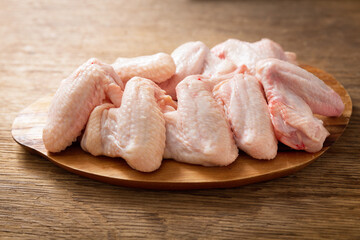 fresh chicken wings on wooden table