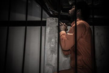 Asian man desperate at the iron prison,prisoner concept,thailand people,Hope to be free,Serious...