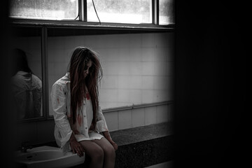 Portrait of asian woman make up ghost face with blood,Horror scene,Scary background,Halloween...