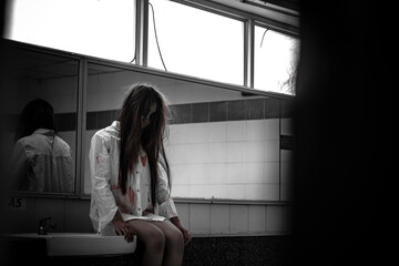 Portrait of asian woman make up ghost face with blood,Horror scene,Scary background,Halloween...