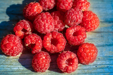 Raspberry on wooden table. Natural food background
