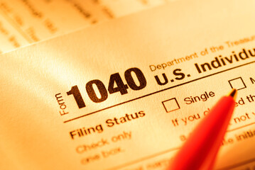 Form 1040 with red pen for US tax declaration