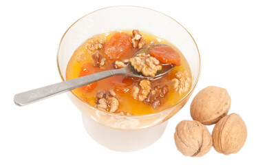 walnuts dried apricots and raisins in a honey with glass bowl isolated on white
