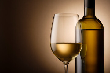 Unlabelled bottle and glass of white wine