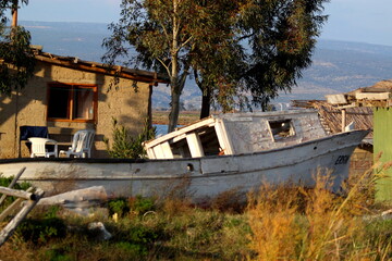 old boat abandoned on the shore of a fishing village
