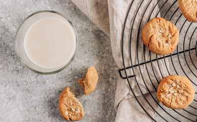 Gluten free homemade oatmeal cookies and oat milk on a light background.