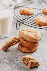 Gluten free homemade oatmeal cookies and oat milk on a light background.