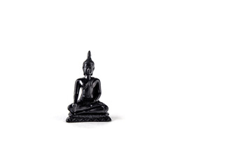 A figure of Buddha of black stone on a white background.