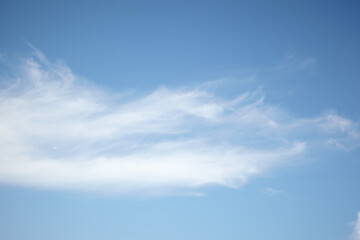 Naklejka na ściany i meble White fluffy clouds on a blue sky.