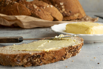 Whole oat sliced bread and fresh butter. Healthy eating concept