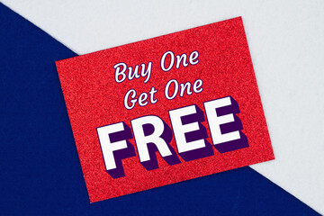 Buy one get one free type message on a glitter red greeting card