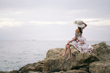 Rear view of young adult asian woman on summer holiday