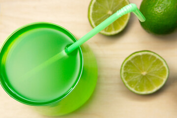 glass of homemade lemonade with lime, selective focus. a refreshing summer lemonade or a Mojito.
