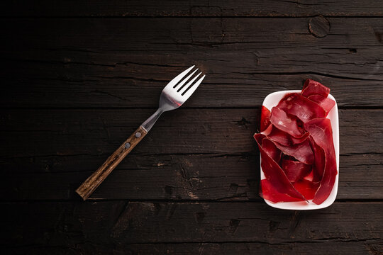 Air-dried meat Tapas : B&uuml;ndnerfleisch, also known as Bindenfleisch or Viande des Grisons, is an air-dried meat that is produced in the canton of Graub&uuml;nden, Switzerland.