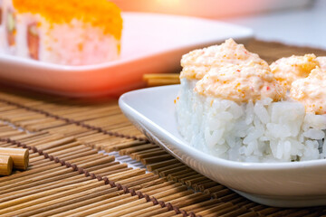 Japanese food restaurant. Sushi with chopsticks, soy sauce, rustic wood background in take away, set delivery box.