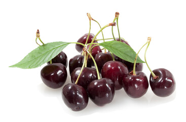cherries with green leaves isolated on white background