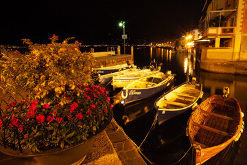 Fototapeta na wymiar Harbour with boats at night in the Italian town of Limone sul Garda
