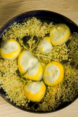 Cooking/making homemade elderberry juice/syrup, lemon, water and sugar