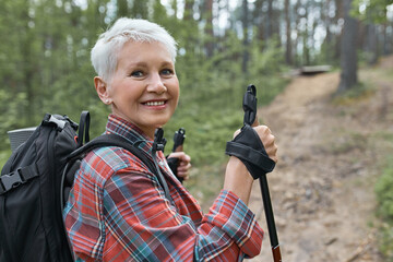 Active lifestyle, aging, travel and hiking concept. Outdoor image of beautiful energetic mature...