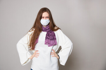 Girl in medical mask on white background empty space