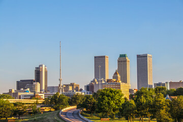 06-14-2020 Tulsa USA - View of downtown skyline from east in early morning with sun reflecting off...